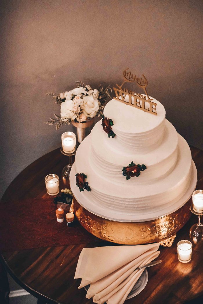 Overhead view of three-tier wedding cake sitting on gold cake stand